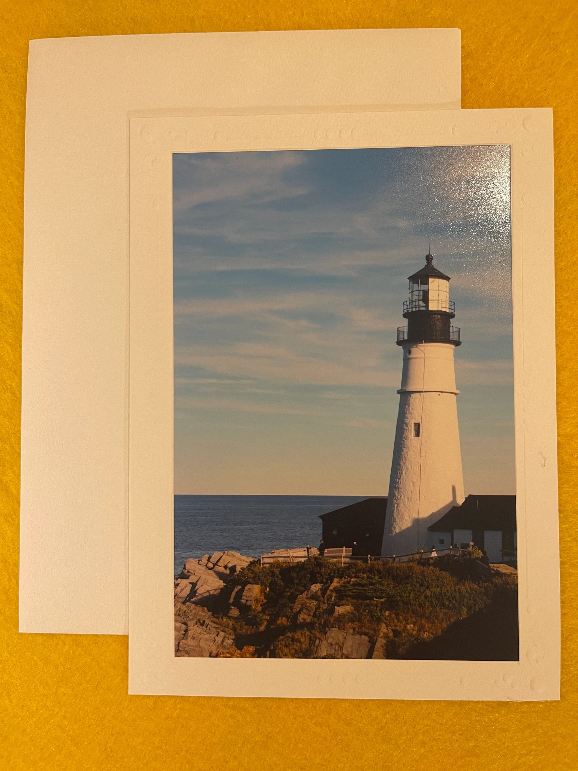 Lighthouse on coastal rocky terrain