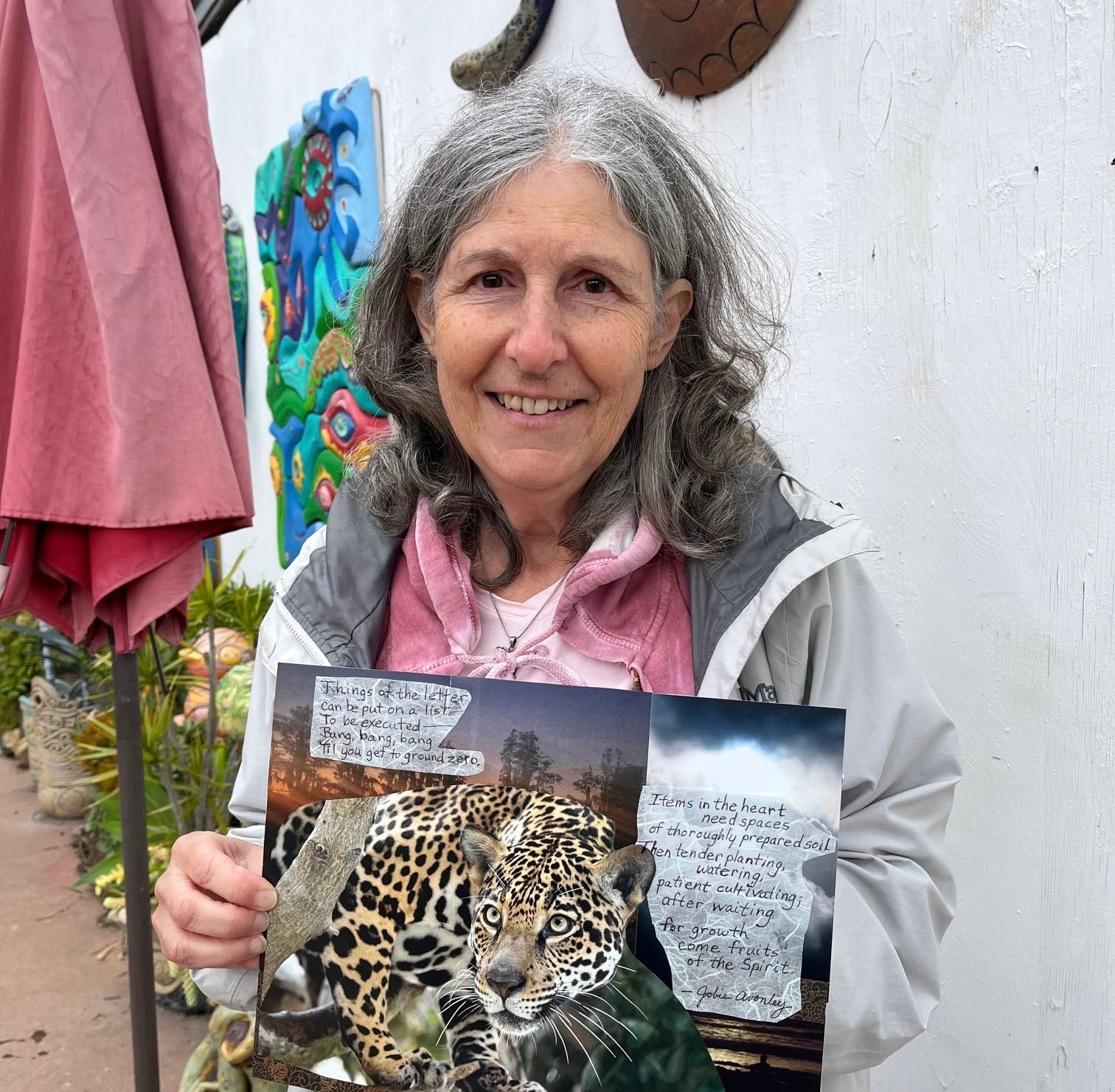 Jobie Avonley holding artwork with poem text